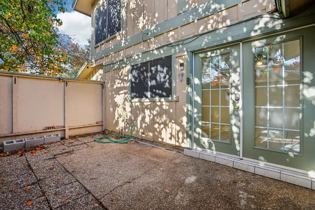 a backyard of a house with lots of green space and fountain
