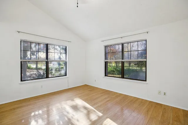 a view of a room with stairs and a floor to ceiling window