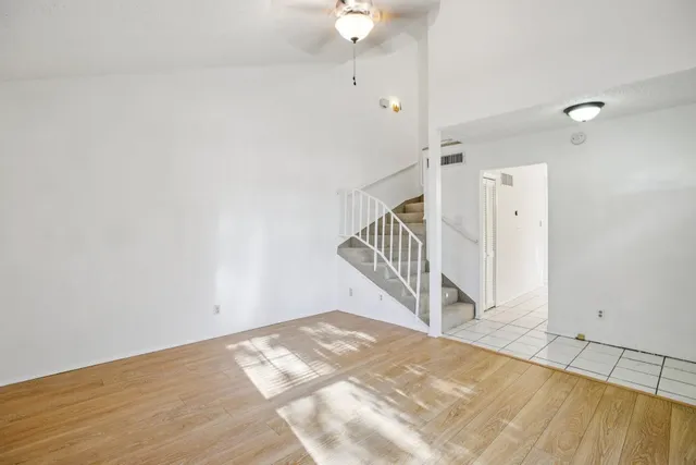 a kitchen with stainless steel appliances kitchen island granite countertop a refrigerator and a stove top oven
