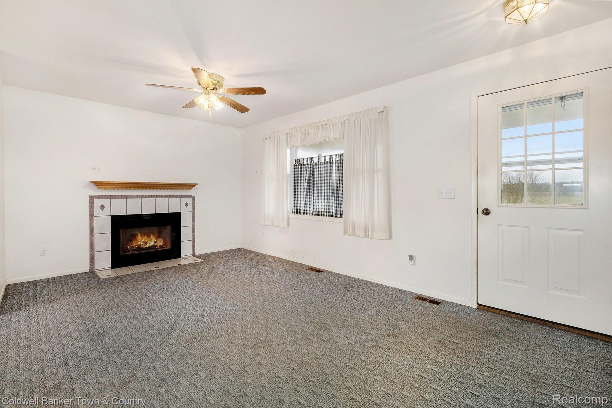 9679 North Nicholson Road Fowlerville, MI 48836 - Photo 3 of 14 Living Room with Gas Fireplace
