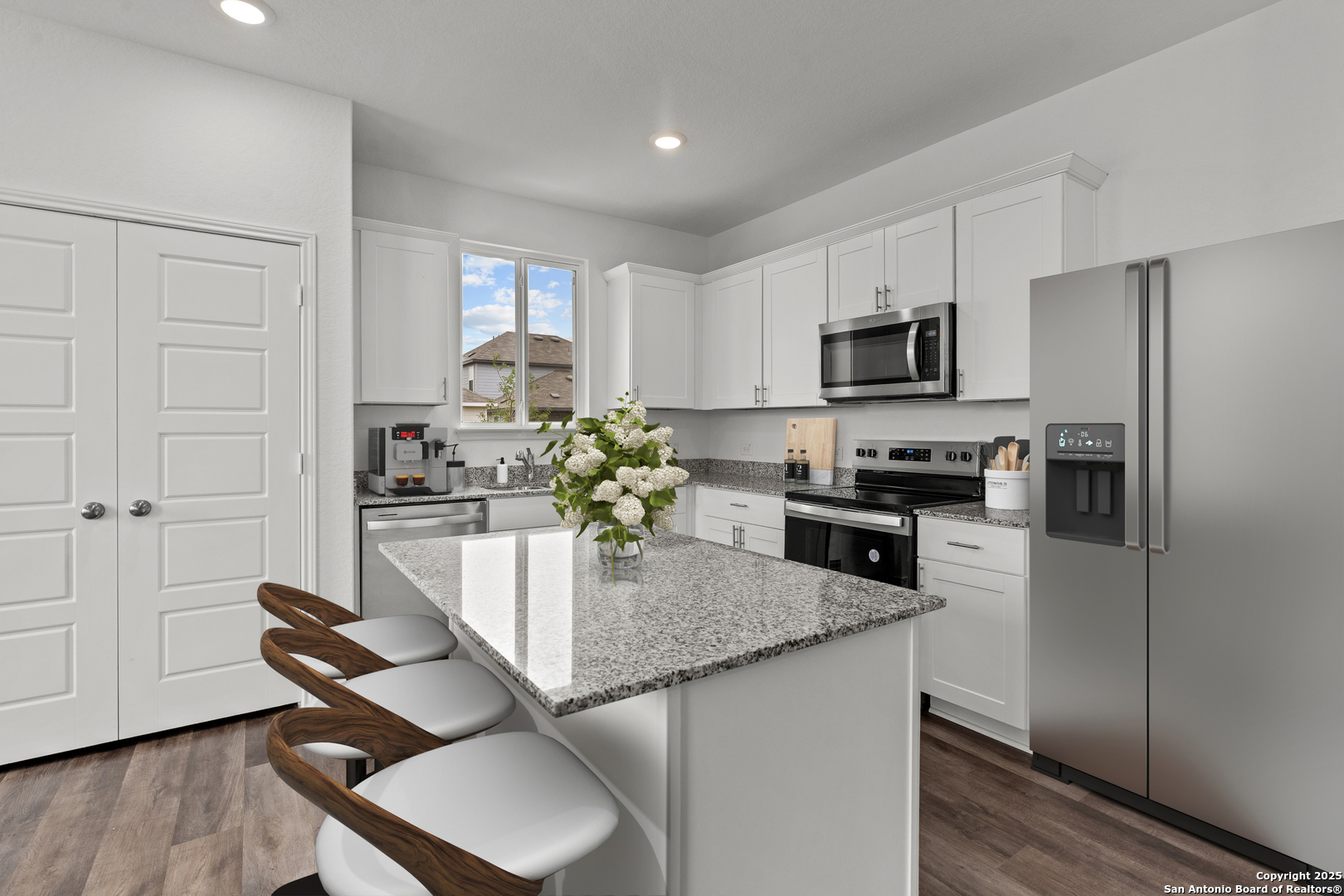 409 Raven Row Marion, TX 78124 - Photo 4 of 6 a kitchen with kitchen island granite countertop a table chairs microwave and cabinets
