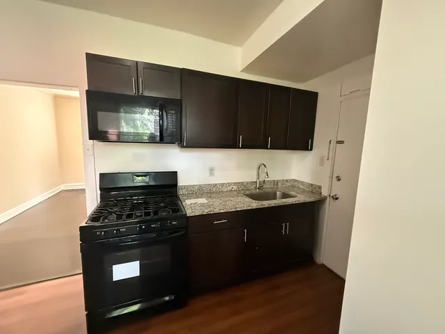 a kitchen with stainless steel appliances a stove and a microwave