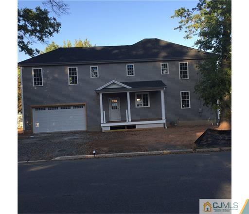 52 West Cliff Road Colonia, NJ 07067 - Photo 18 of 18 a front view of a house with a yard and garage