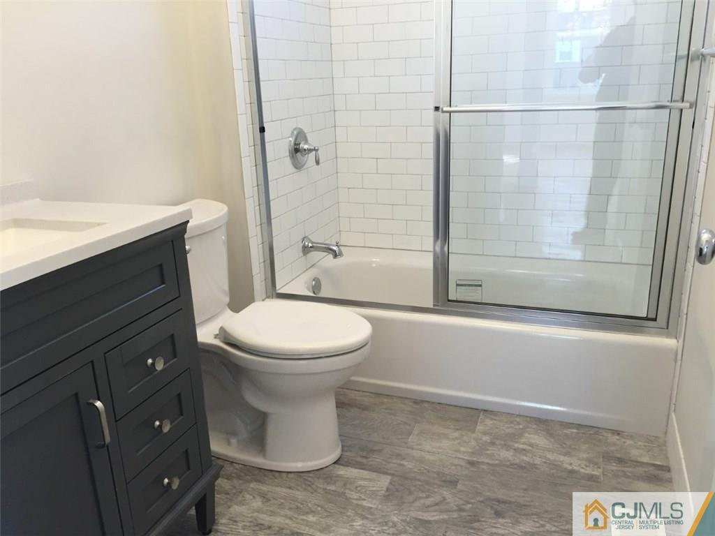 52 West Cliff Road Colonia, NJ 07067 - Photo 5 of 18 a bathroom with a toilet a sink and shower