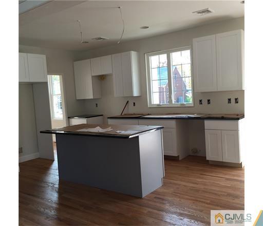 52 West Cliff Road Colonia, NJ 07067 - Photo 6 of 18 a kitchen with a sink and cabinets