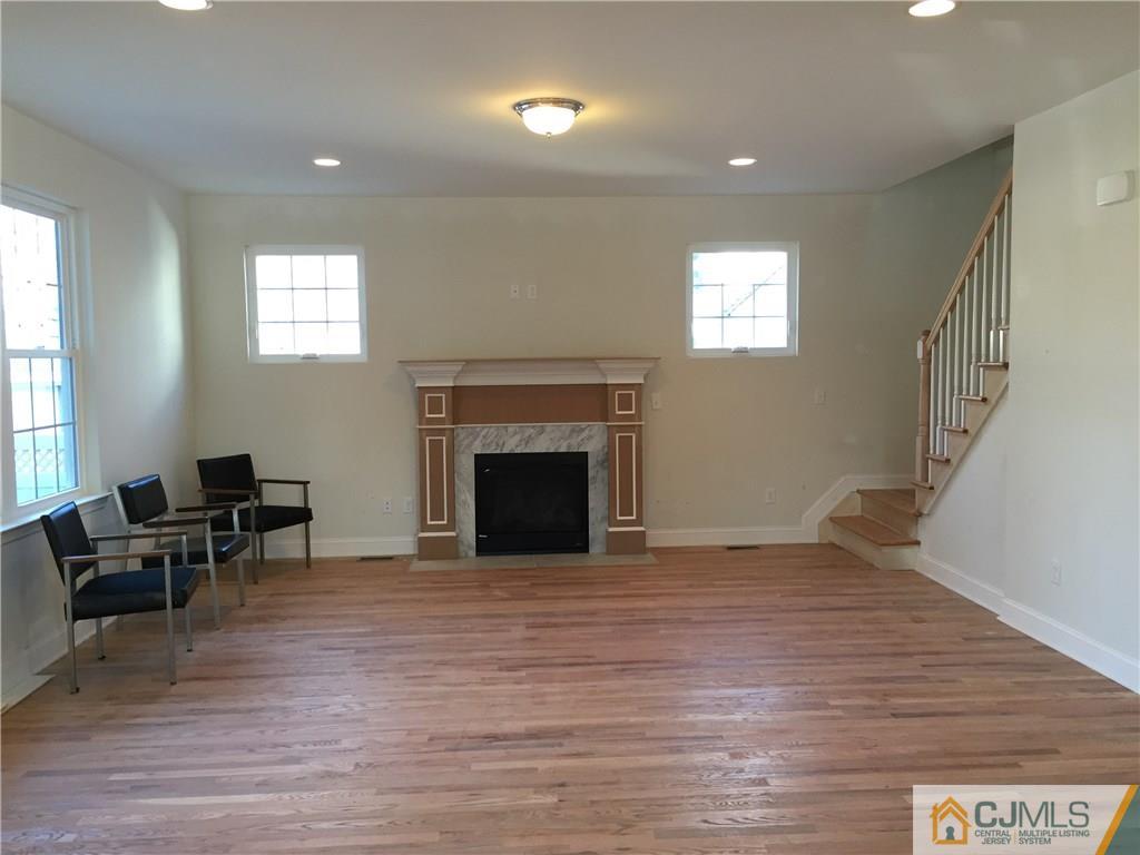 52 West Cliff Road Colonia, NJ 07067 - Photo 7 of 18 a view of a livingroom with furniture and a fireplace