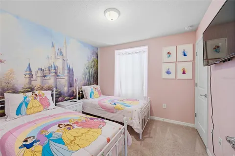 a bedroom with bed and wooden floor