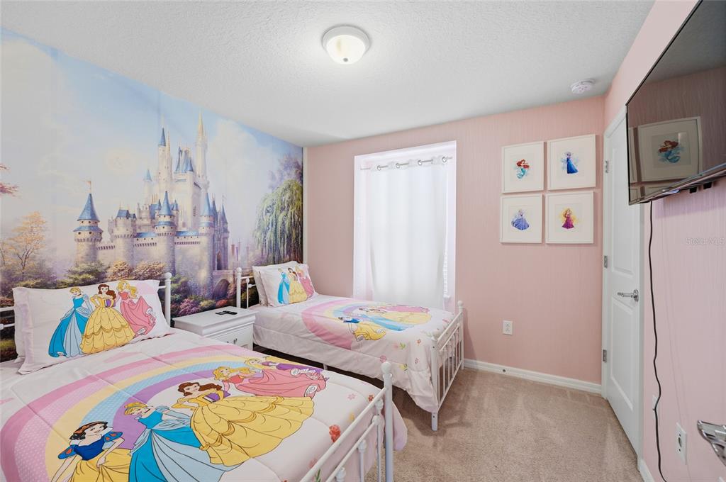 236 Jetty Way Davenport, FL 33897 - Photo 13 of 25 a bedroom with bed and wooden floor