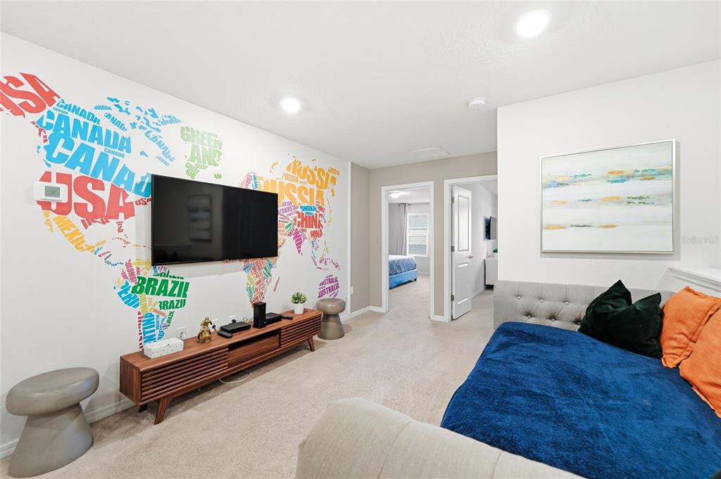 236 Jetty Way Davenport, FL 33897 - Photo 20 of 25 a living room with furniture and a flat screen tv