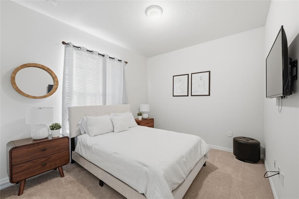 236 Jetty Way Davenport, FL 33897 - Photo 22 of 25 a bedroom with a bed and a window