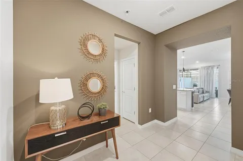 a living room with table and a mirror