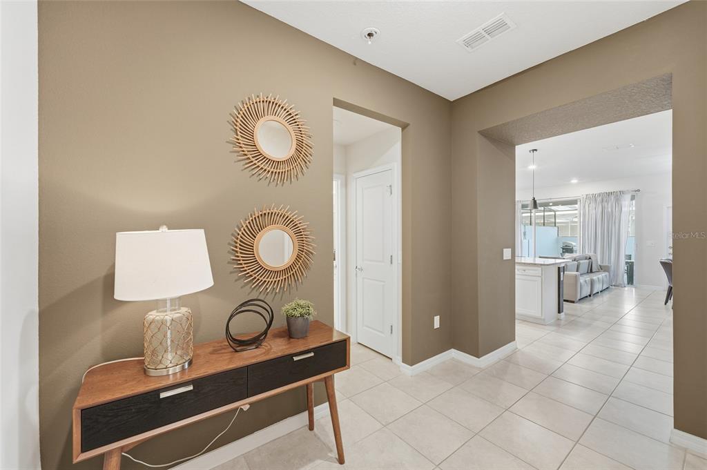 236 Jetty Way Davenport, FL 33897 - Photo 23 of 25 a living room with table and a mirror