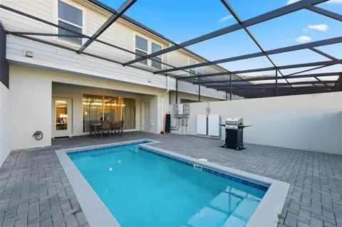 a view of an outdoor space with pool and windows