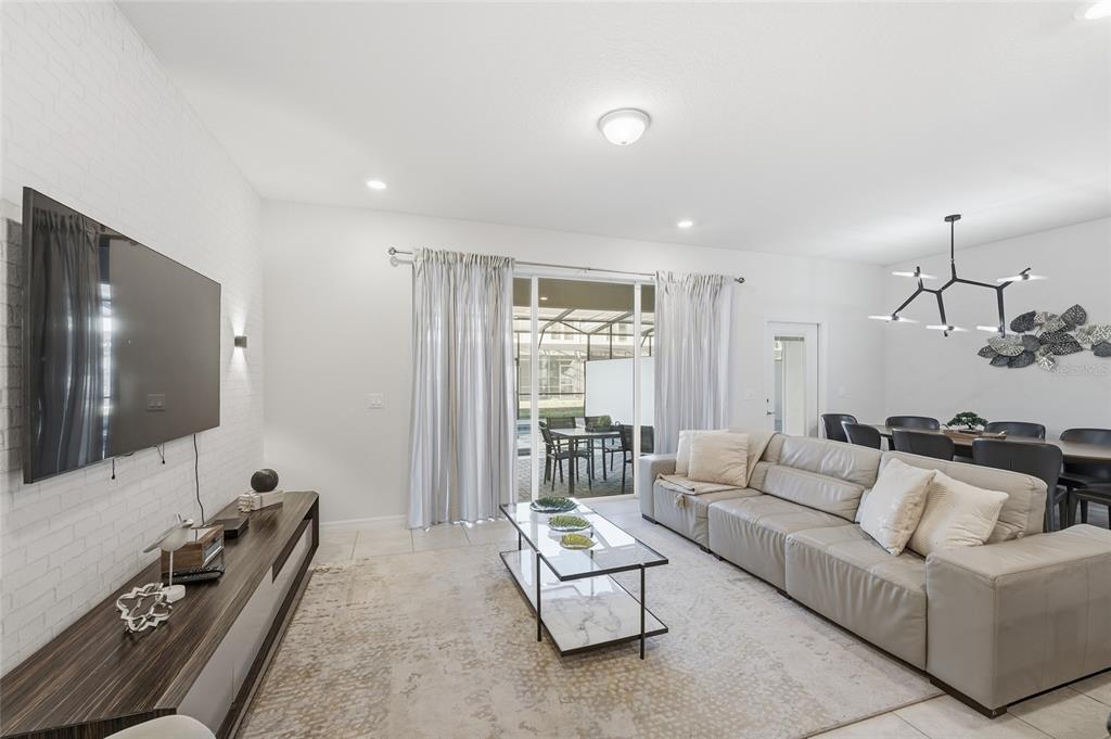 236 Jetty Way Davenport, FL 33897 - Photo 6 of 25 a living room with furniture and a flat screen tv
