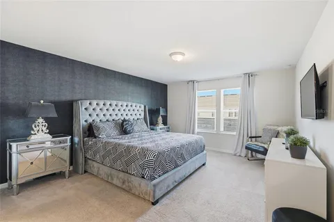 a bedroom with a bed chair and a window