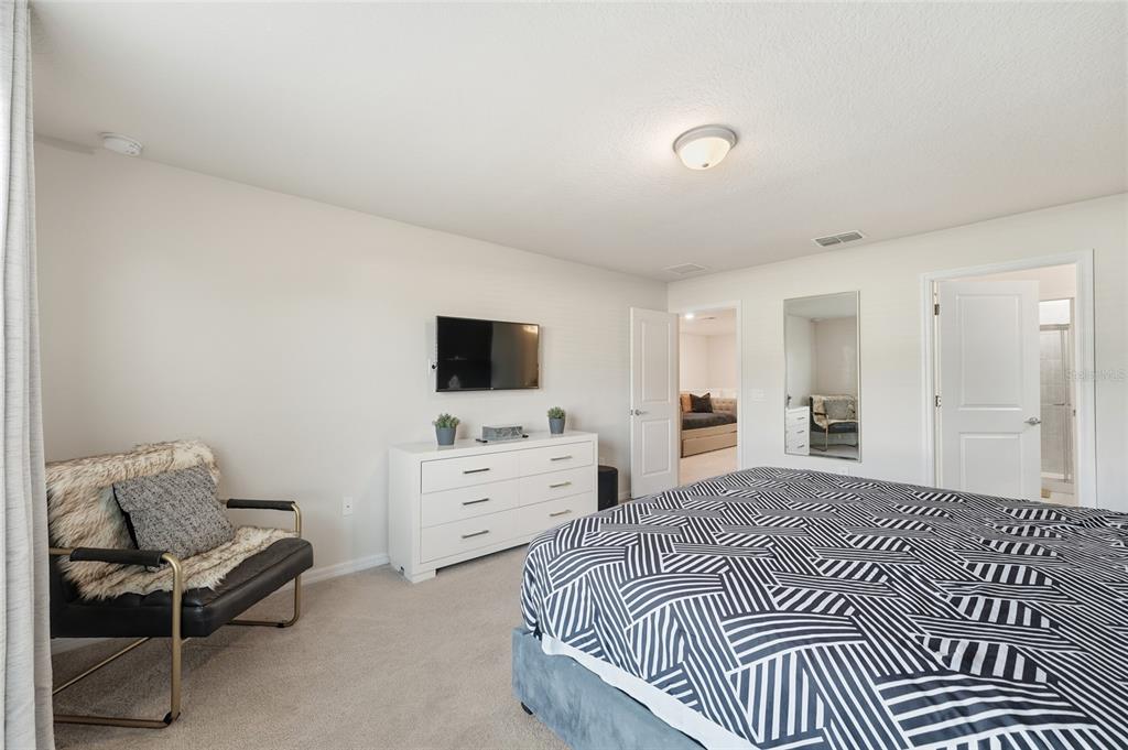 236 Jetty Way Davenport, FL 33897 - Photo 10 of 25 a bedroom with a bed and flat screen tv