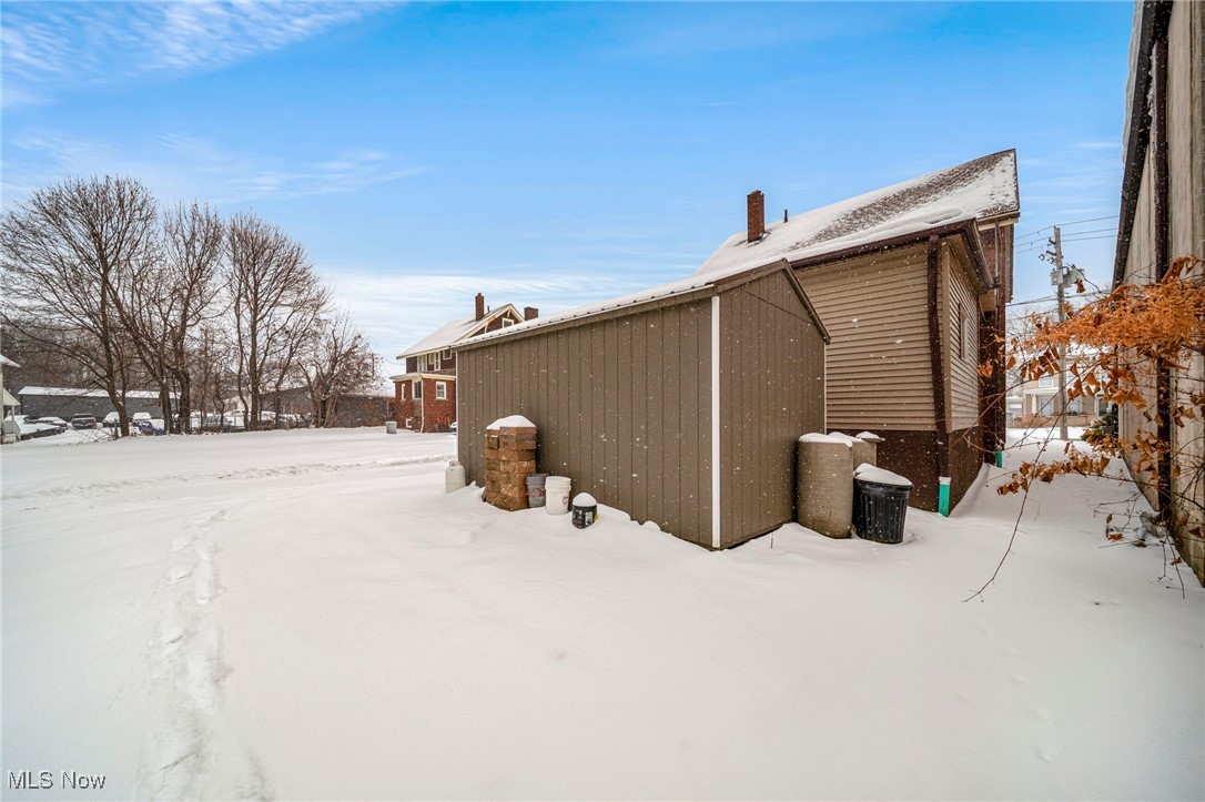 977 West Prospect Road Ashtabula, OH 44004 - Photo 37 of 42 Snow covered property featuring an outbuilding