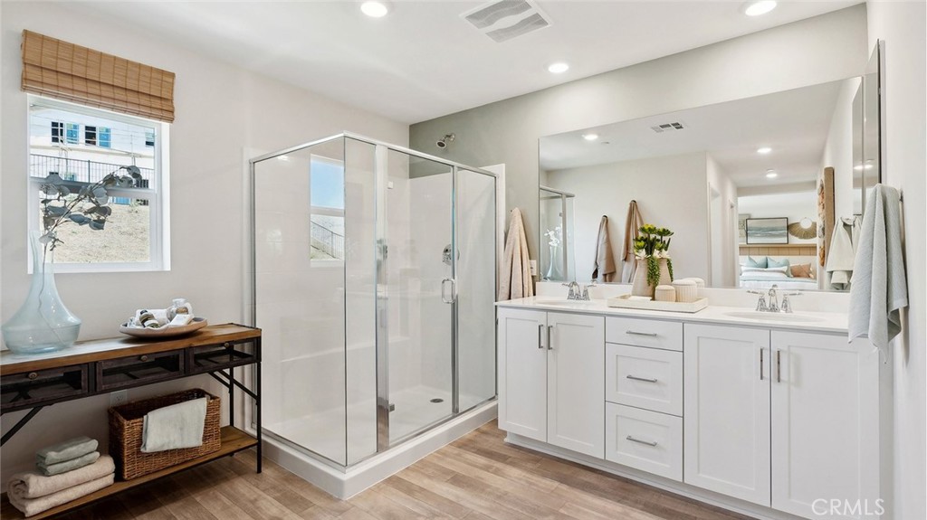 11392 Forge Road Corona, CA 92883 - Photo 18 of 24 a bathroom with a shower sink and mirror