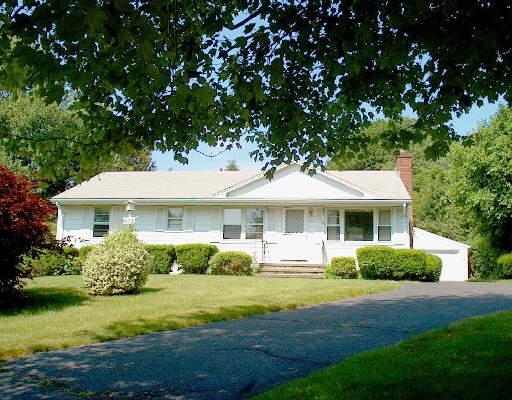 933 Huntington Road Stratford, CT 06614 - Photo 1 of 1 a front view of a house with a garden