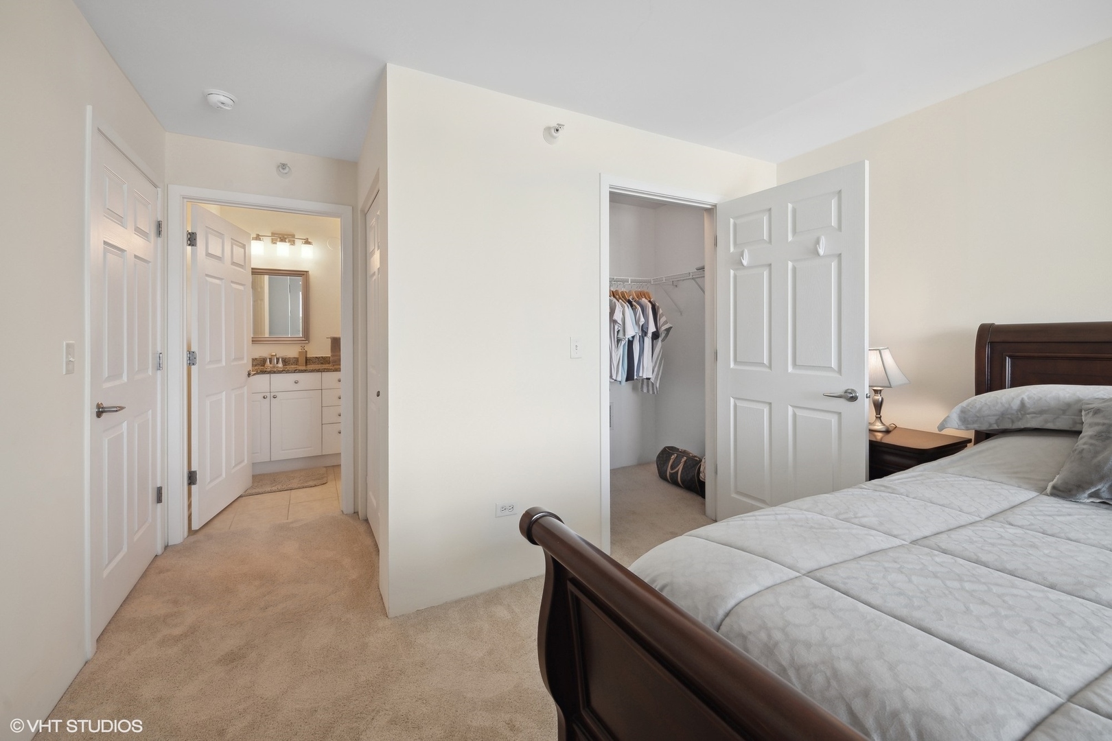 1640 Maple Avenue, Unit 704 Evanston, IL 60201 - Photo 11 of 15 a bedroom with a bed and a chandelier