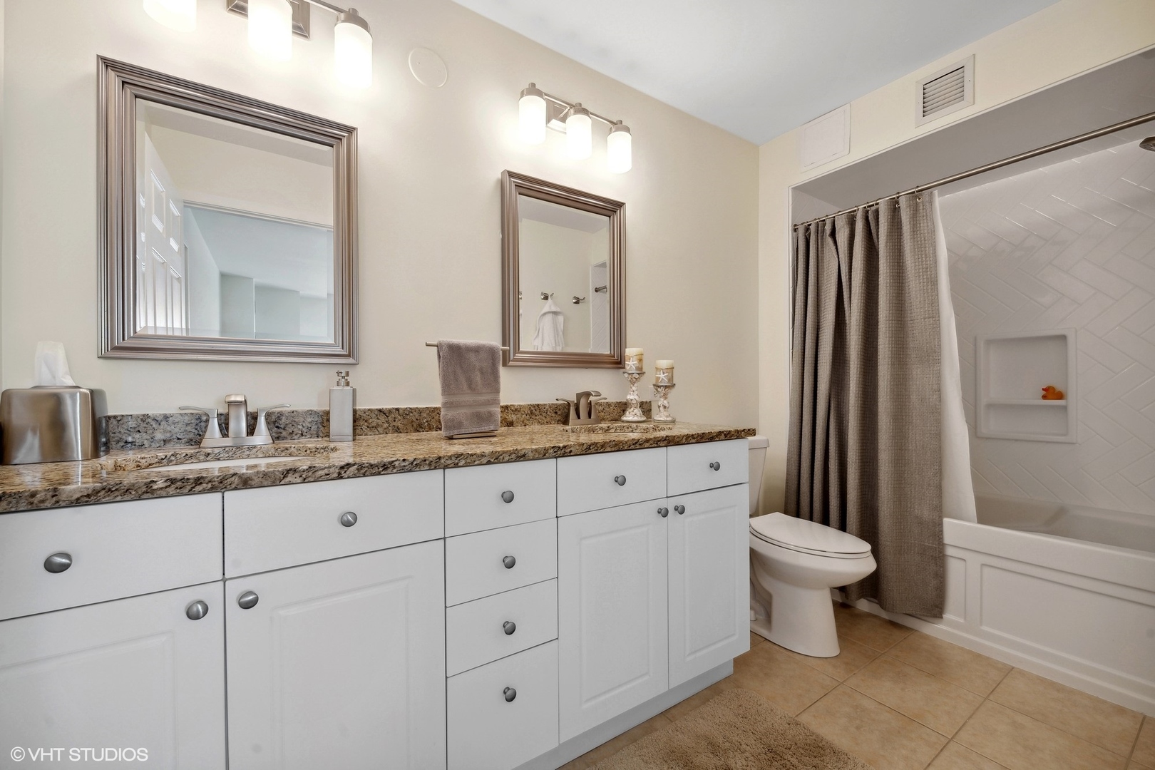 1640 Maple Avenue, Unit 704 Evanston, IL 60201 - Photo 12 of 15 a bathroom with double sink toilet a mirror and shower