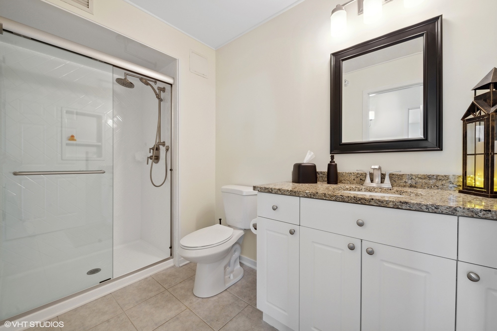 1640 Maple Avenue, Unit 704 Evanston, IL 60201 - Photo 13 of 15 a bathroom with a granite countertop sink toilet and shower