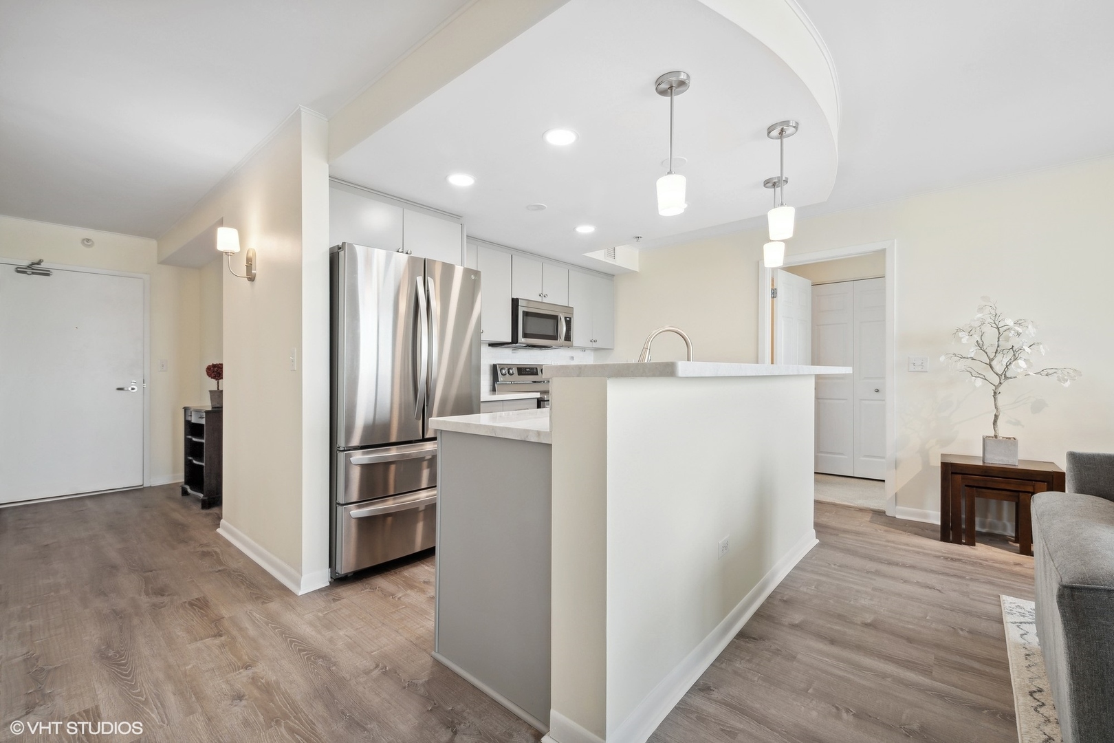 1640 Maple Avenue, Unit 704 Evanston, IL 60201 - Photo 5 of 15 a view of a kitchen with refrigerator and wooden floor