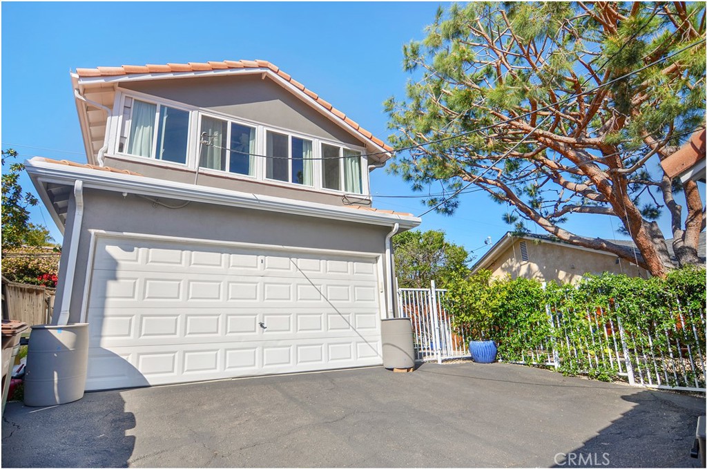 34556 Calle Naranja, Unit A Dana Point, CA 92624 - Photo 1 of 12 a front view of a house with a garage