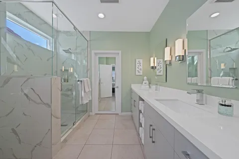 a spacious bathroom with a shower sink and mirror
