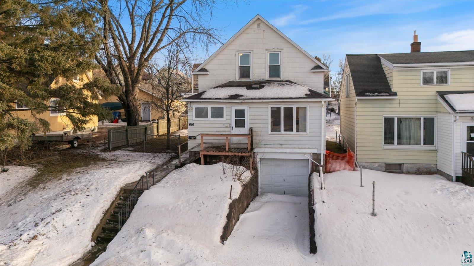 616 Summit Street Eveleth, MN 55734 - Photo 1 of 42 Snow covered house featuring an attached garage