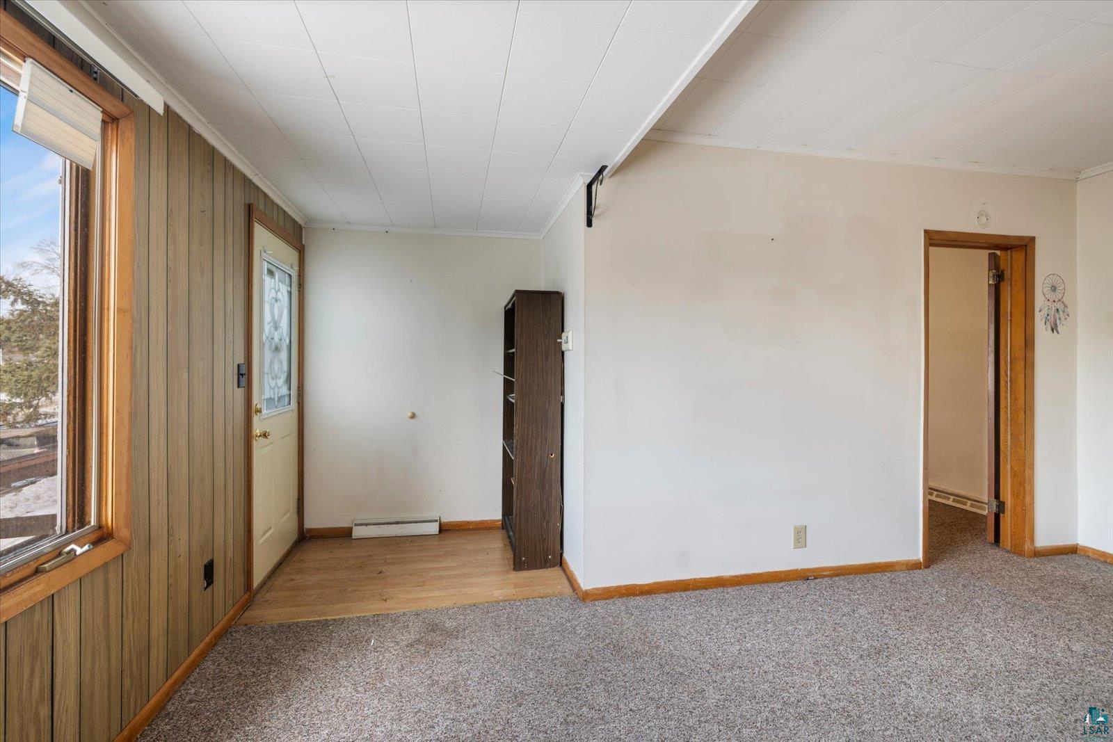 616 Summit Street Eveleth, MN 55734 - Photo 14 of 42 Empty room featuring light colored carpet and crown molding