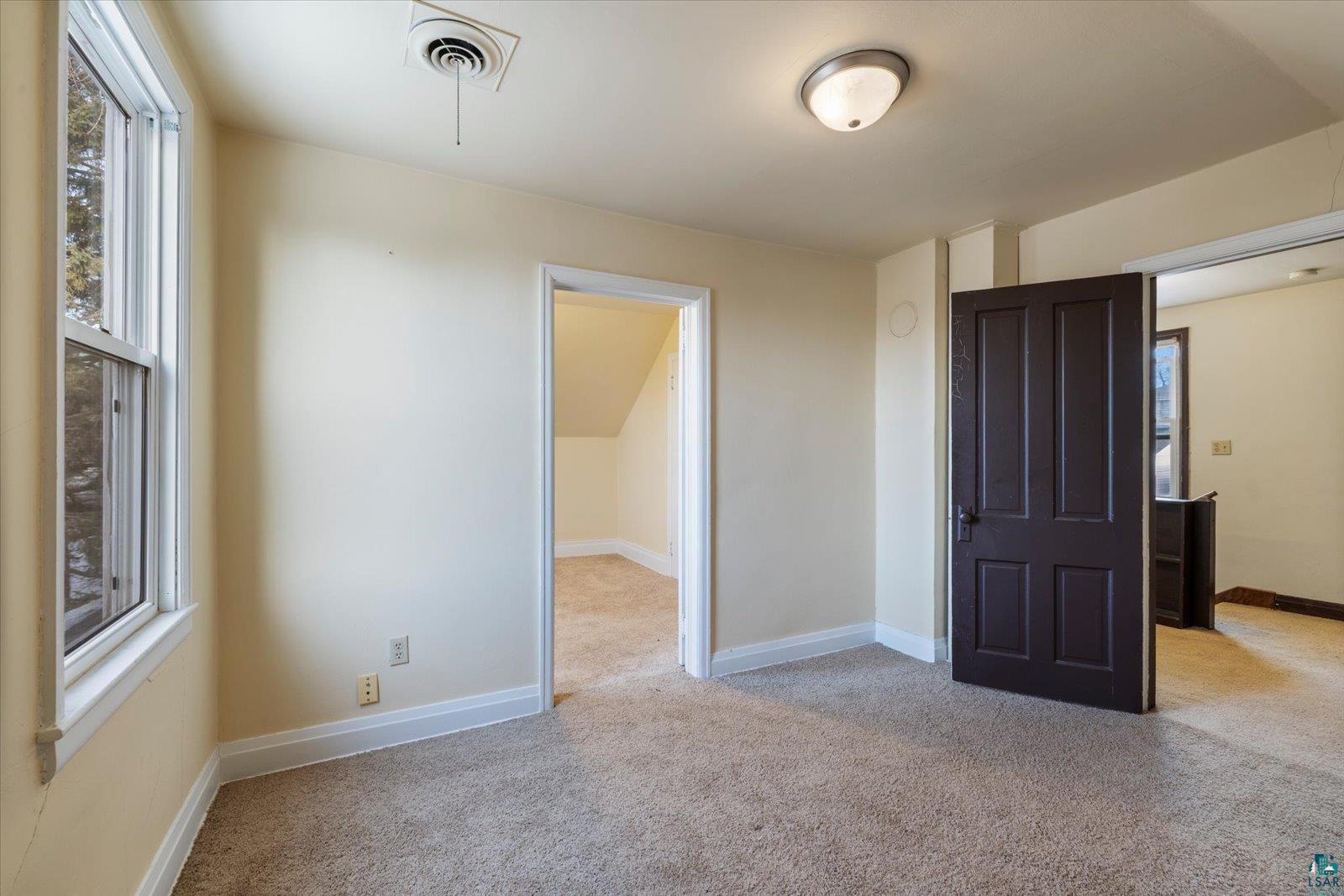 616 Summit Street Eveleth, MN 55734 - Photo 22 of 42 Unfurnished bedroom featuring multiple windows and light colored carpet