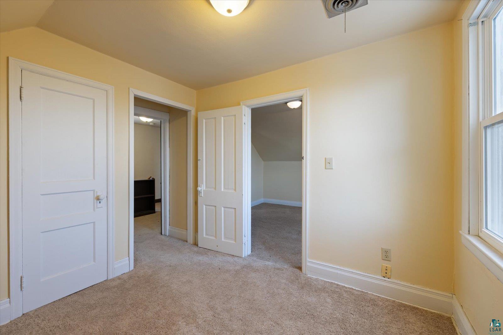 616 Summit Street Eveleth, MN 55734 - Photo 24 of 42 Unfurnished bedroom featuring light colored carpet and multiple windows