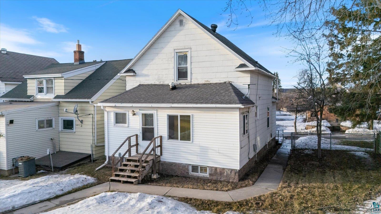 616 Summit Street Eveleth, MN 55734 - Photo 3 of 42 Rear view of house featuring roof with shingles and a chimney