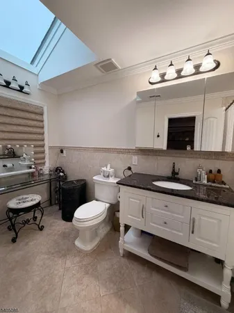 a bathroom with a sink mirror and toilet