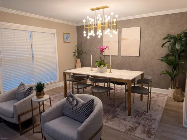 a living room with furniture a chandelier and a dining table