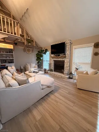 a living room with furniture fireplace and flat screen tv