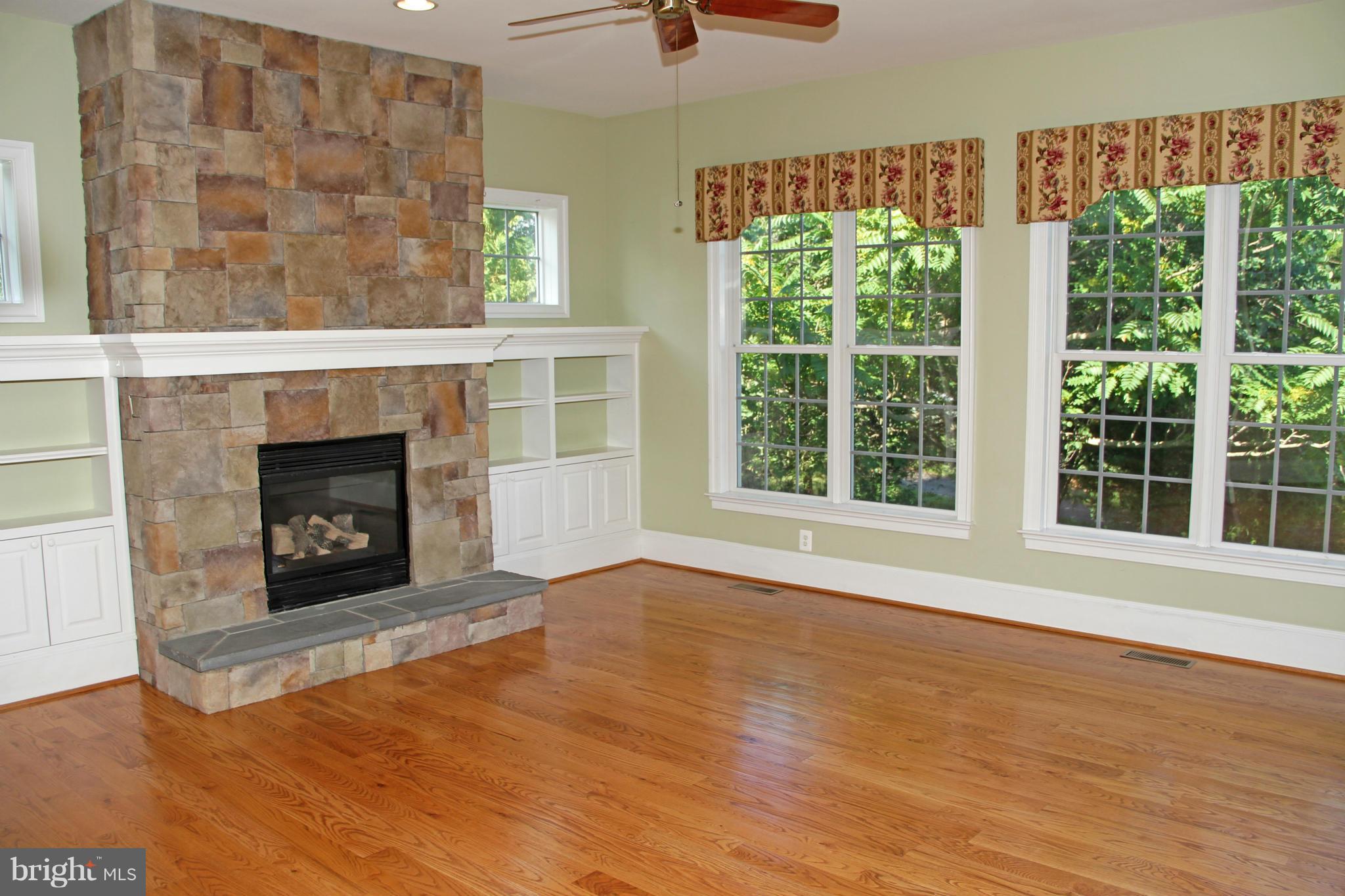 8288 Roxborough Loop Gainesville, VA 20155 - Photo 8 of 30 Family Room offers Stone Fireplace and Built-ins