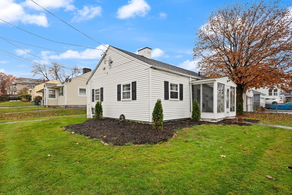 83 Oakside Avenue Methuen, MA 01844 - Photo 18 of 22 a view of a yard in front of a house with a large tree
