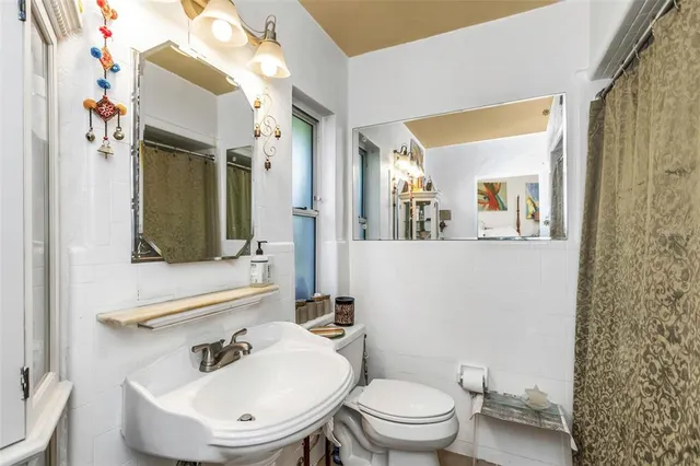 a bedroom with a bed and a lamp