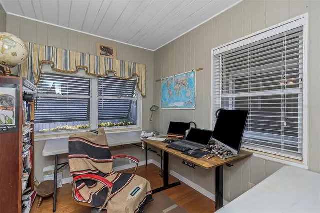 a view of a yard with plants and trees