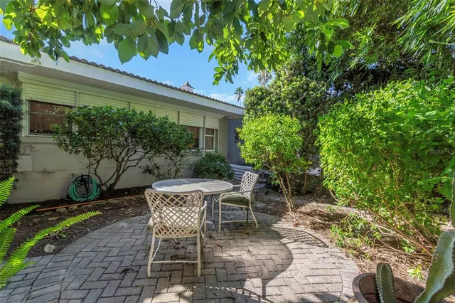 a wooden table and chairs in a patio