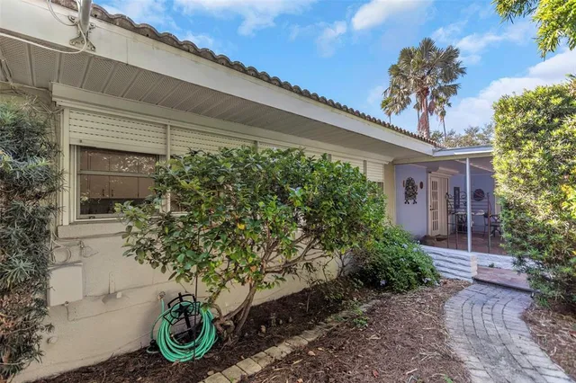 an aerial view of a house with a garden and trees