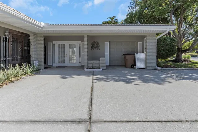 an aerial view of residential houses with outdoor space and trees