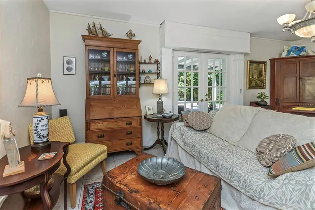 a dining room with wooden floor a chandelier a wooden table and chairs