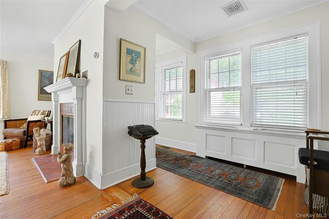 a view of a livingroom with furniture a ceiling fan and windows