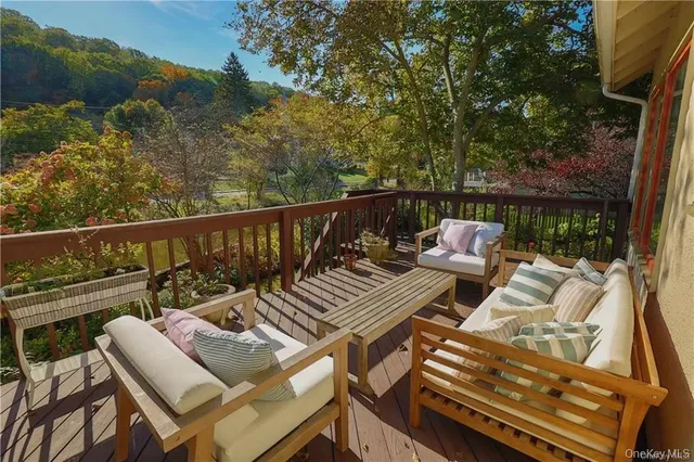 a view of balcony with wooden floor and outdoor seating