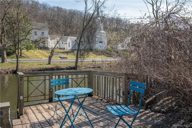 a view of balcony with wooden floor and outdoor seating