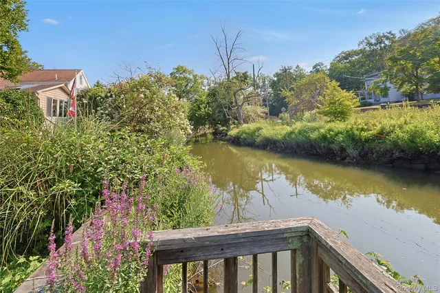 a view of a lake with a house in the background