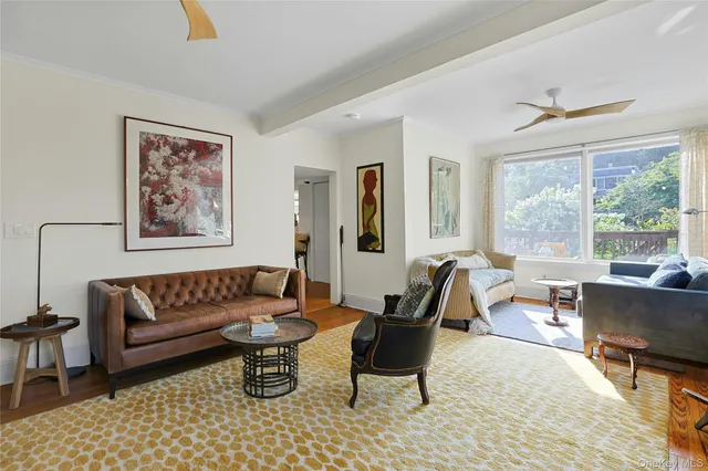 a living room with furniture large window and a table